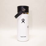 White Hydro Flask water bottle with black lid on a light beige background
