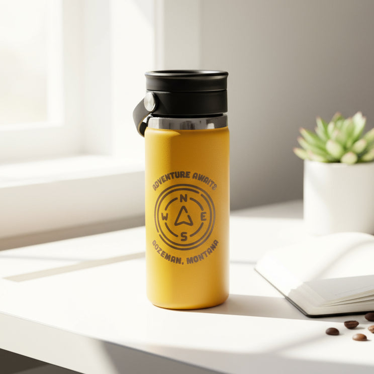Yellow water bottle with black lid and 'Adventure Awaits' text on a white background