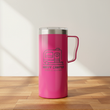 Pink insulated mug with 'Happy Camper' text on a wooden surface