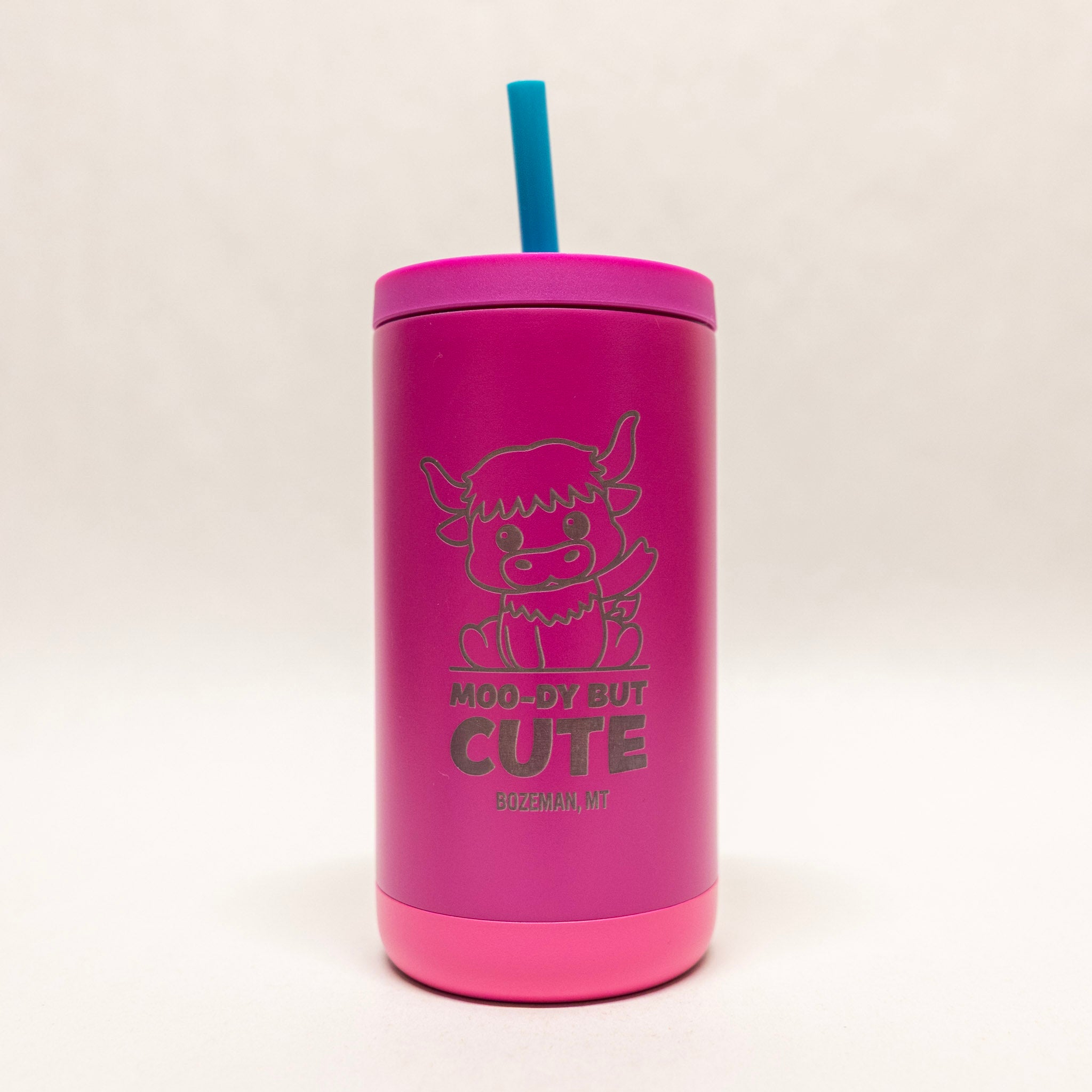 Pink tumbler with a straw on a white background