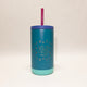 Blue tumbler with 'Wild Child' text and purple straw on a beige background