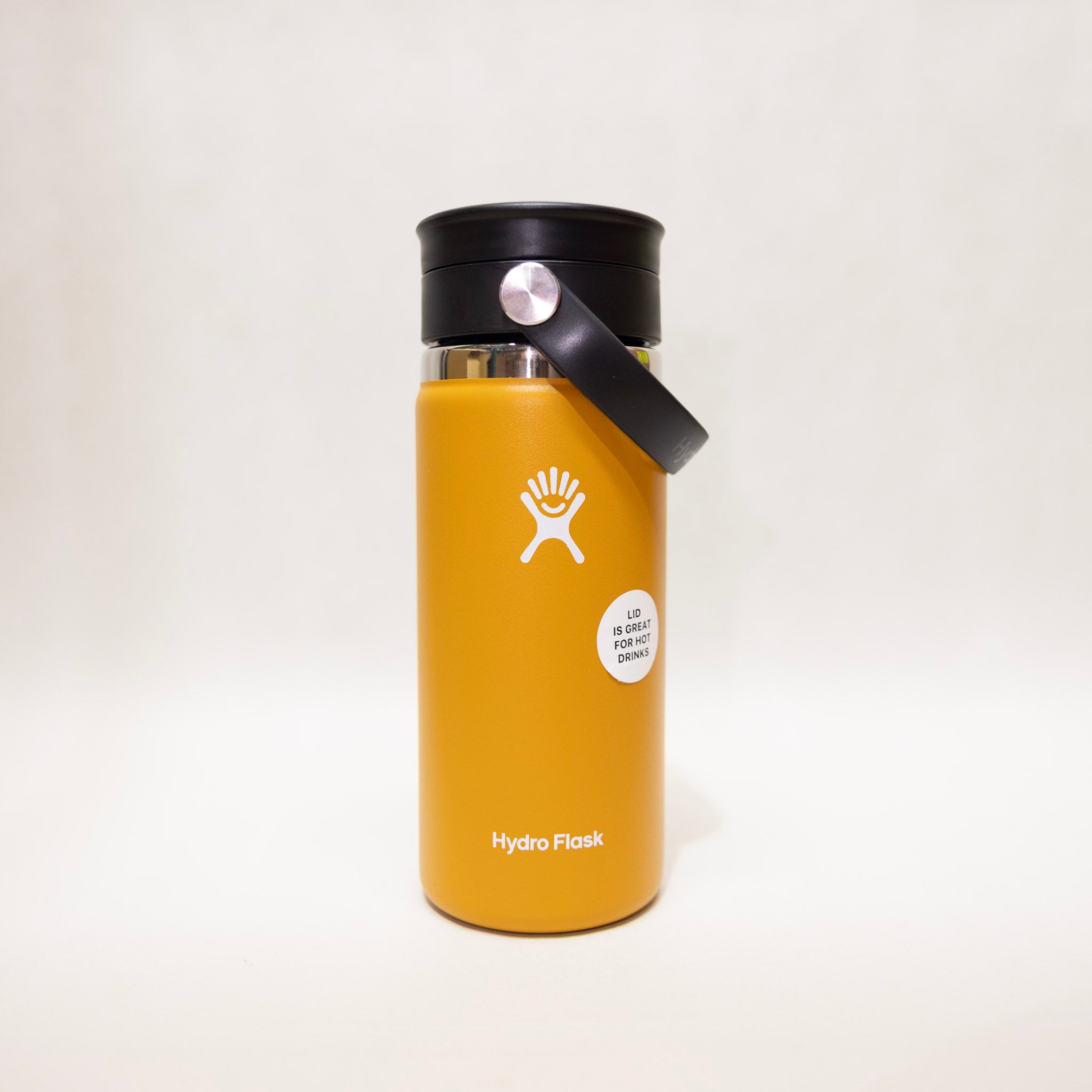 Yellow Hydro Flask bottle with black lid on a white background