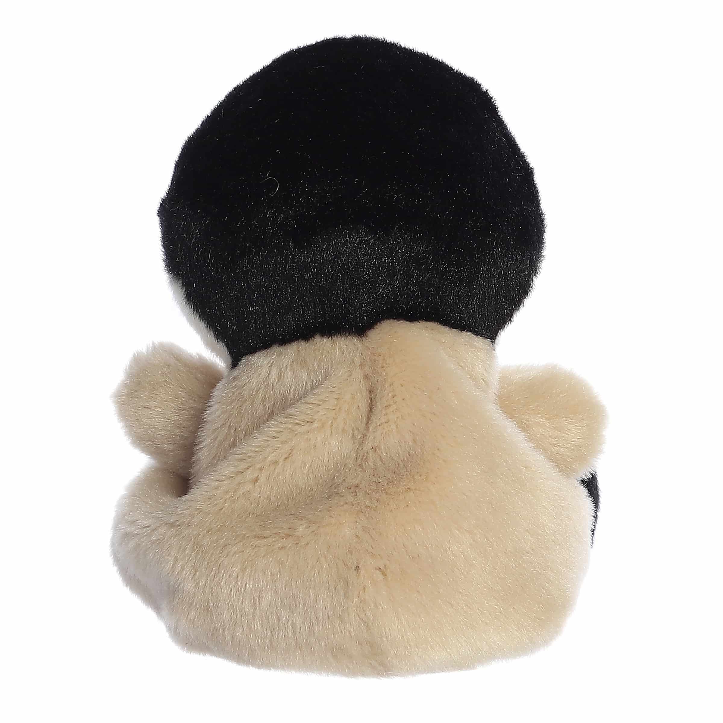 Plush toy penguin with black, white, and brown colors on a white background