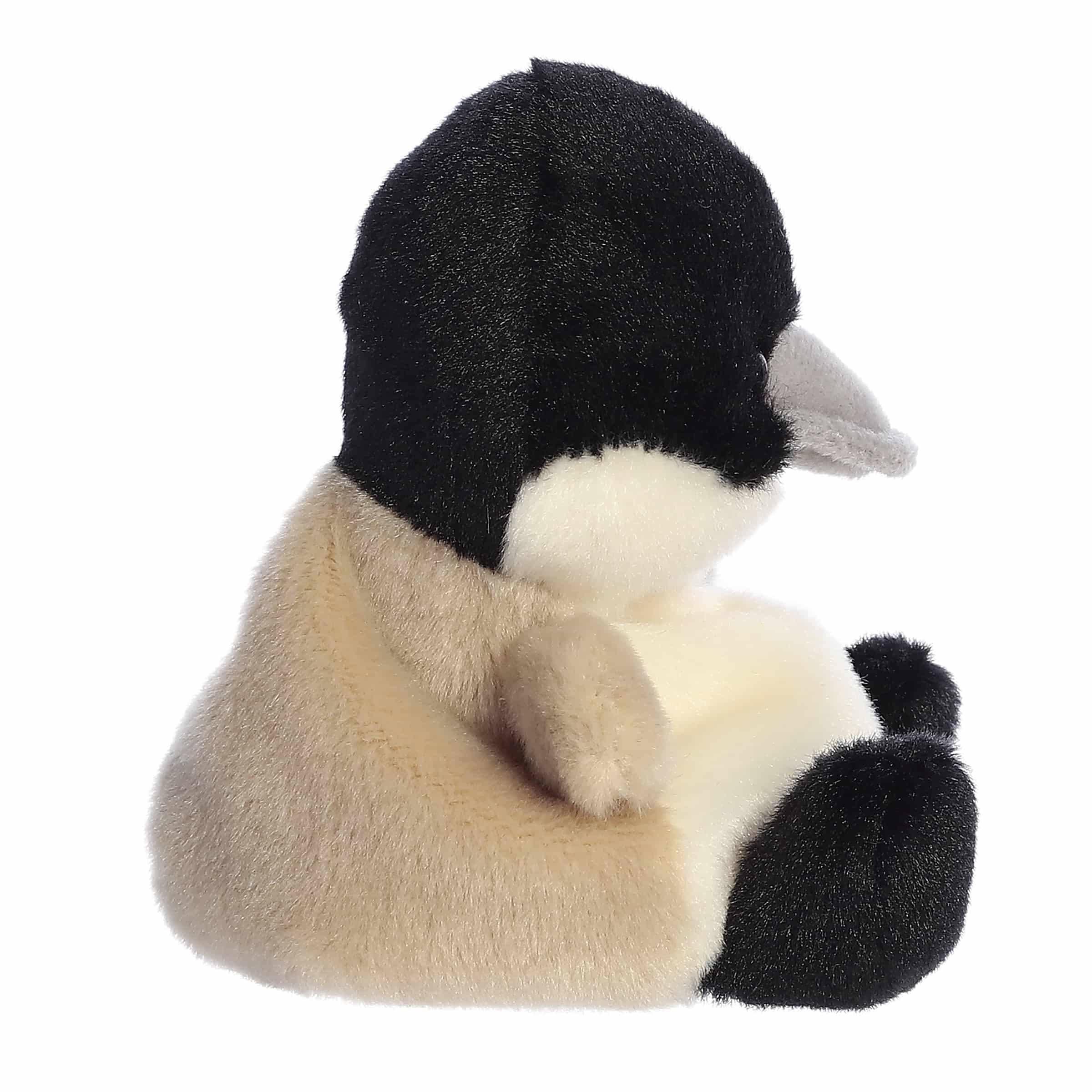 Plush toy penguin with black, white, and brown colors on a white background
