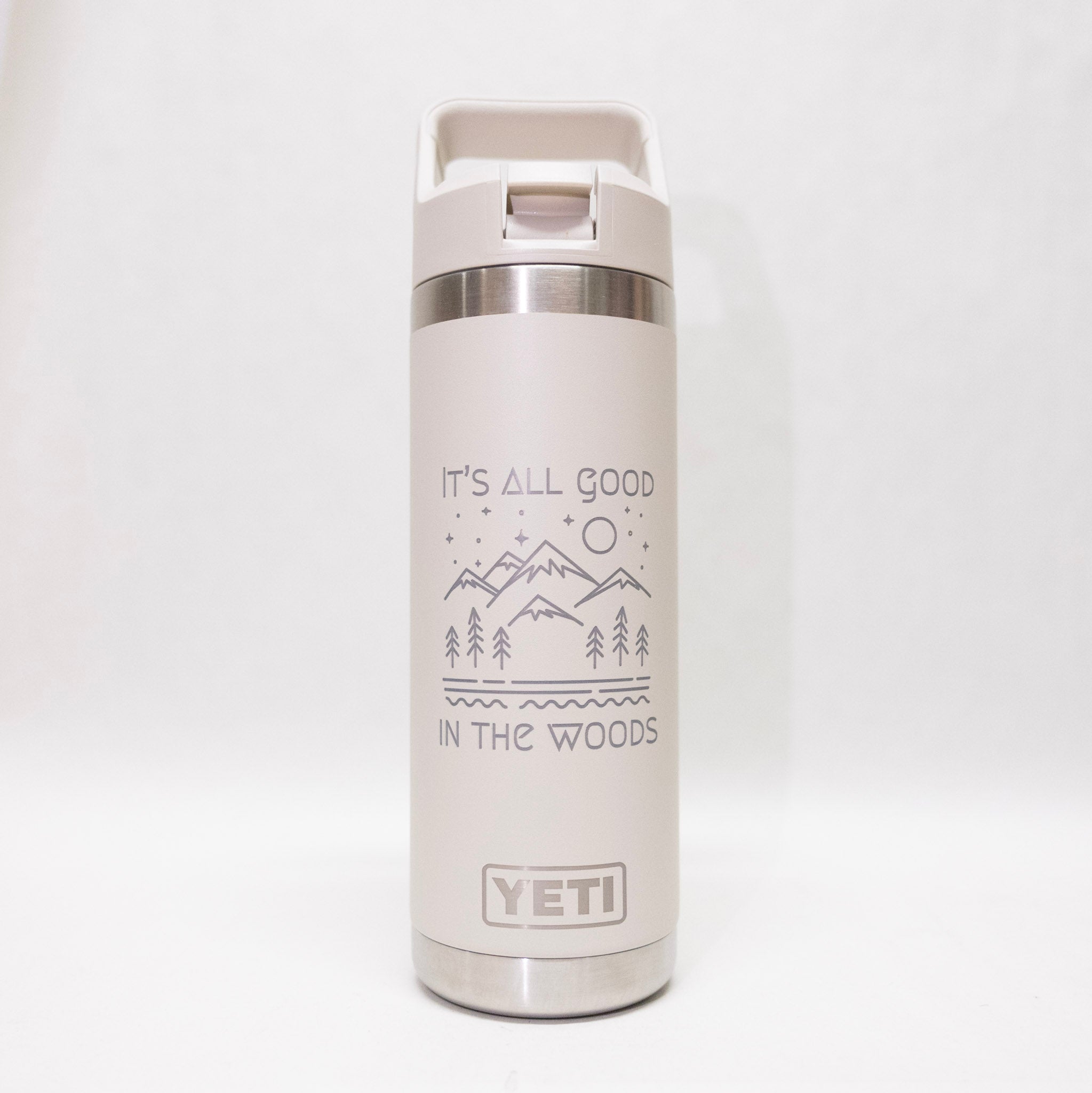 White YETI water bottle with nature-themed design and 'It's All Good in the Woods' text on a white background