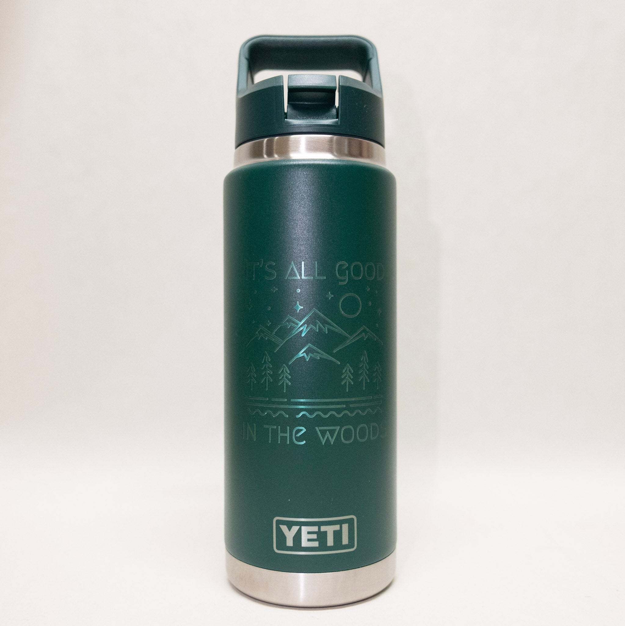 Green YETI water bottle with nature-themed design on a white background