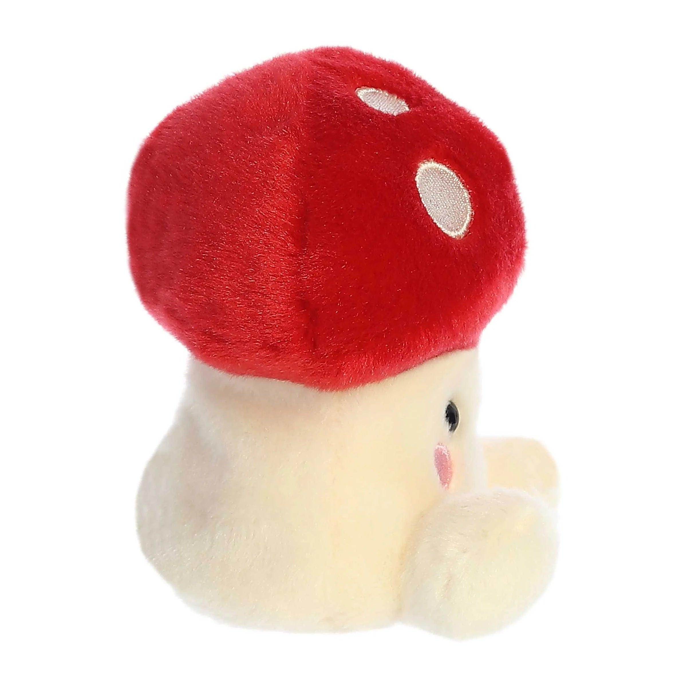 Plush toy shaped like a mushroom with a red cap and white body on a white background