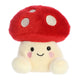 Plush toy shaped like a mushroom with a red cap and white body on a white background