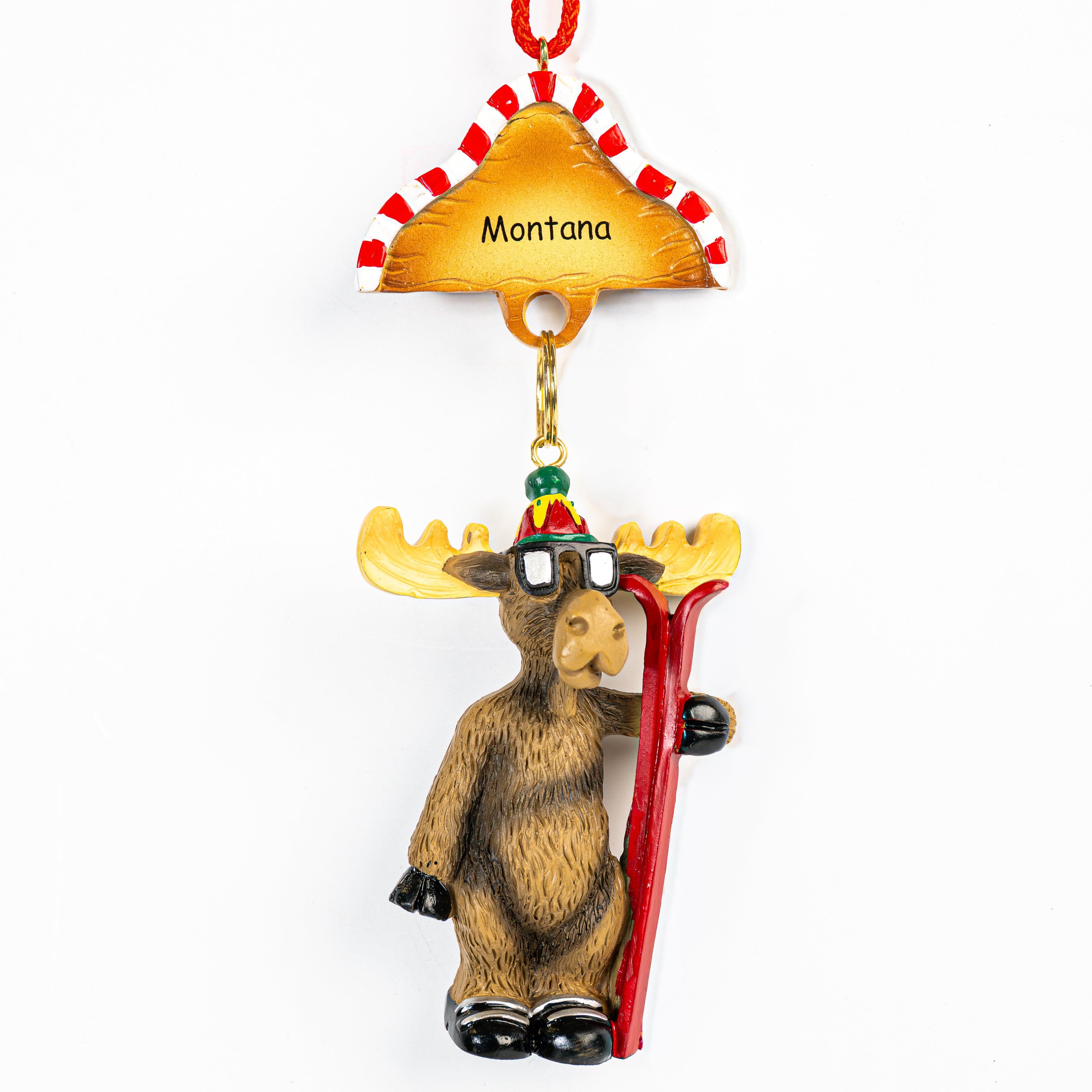 Moose ornament with skis and 'Montana' hat on a white background