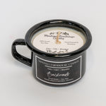 Black mug with a candle labeled 'Montana Farmhouse Candles' on a light gray background