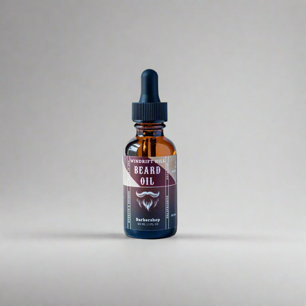Bottle of beard oil with a dropper on a white background
