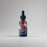 Bottle of beard oil with a dropper on a white background