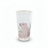 A frosted glass tumbler featuring a hand-drawn illustration of a brown bear surrounded by blue leaves, set on a white surface