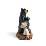 Bear and person figurine with a hat on a white background