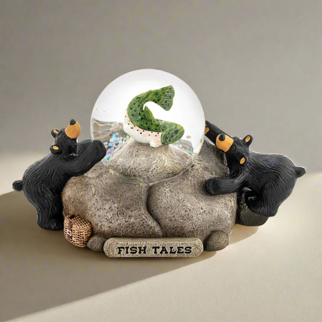 Decorative figurine with two bears and a snow globe labeled 'Fish Tales' on a white background