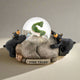 Decorative figurine with two bears and a snow globe labeled 'Fish Tales' on a white background