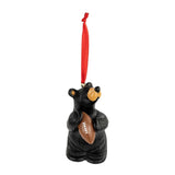 Black bear ornament holding a football with a red ribbon on a white background