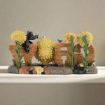 Decorative garden sculpture with flowers and a bear, featuring the word 'WILD' on a white background.