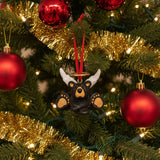 Black bear ornament with antlers on a red ribbon against a white background