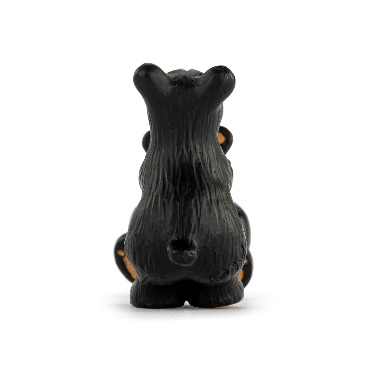 Backside of a black bear on a white background.