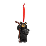 Black bear ornament with a red ribbon on a white background