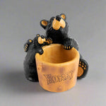 Two Bearfoots Bears embracing near a large wooden pot labeled 'honey'. Resin Bearfoots Honey Pot Paper Clip Holder by Demdaco
