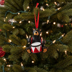 Decorative Bearfoots bear ornament with drum and red ribbon