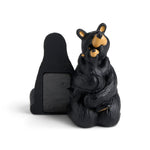 Black bear statue with a cub on a white background