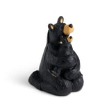 Black bear statue with a cub on a white background