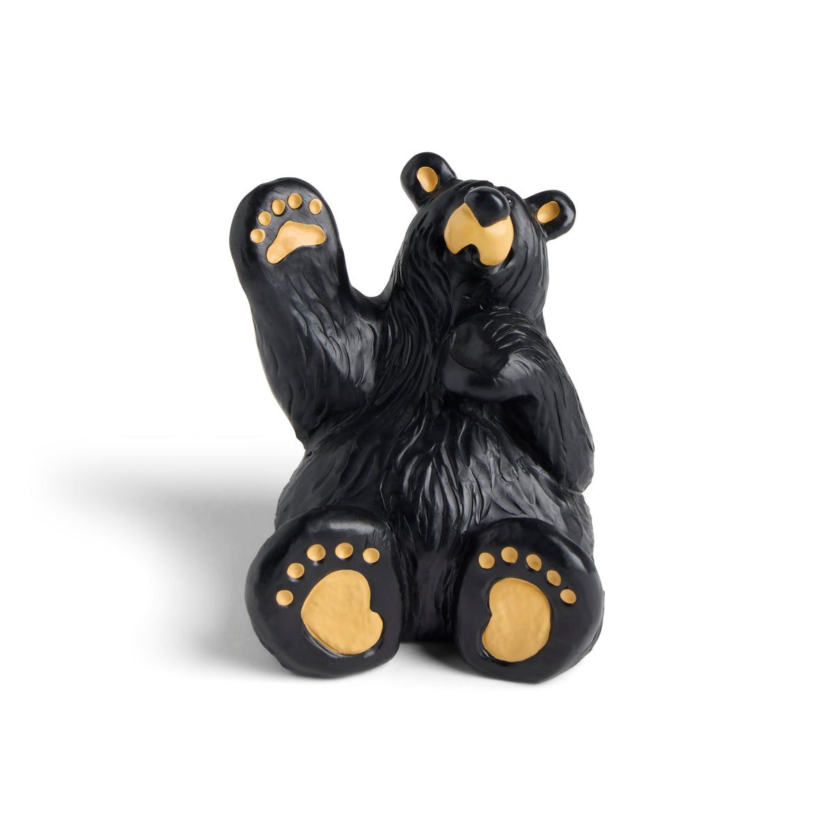 Black bear figurine with gold paw pads on a white background