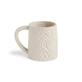 White ceramic mug with textured design on a white background