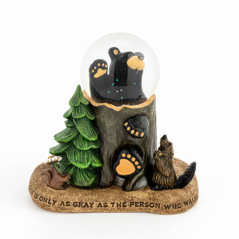 Decorative figurine with bears, a tree, and a snow globe on a white background