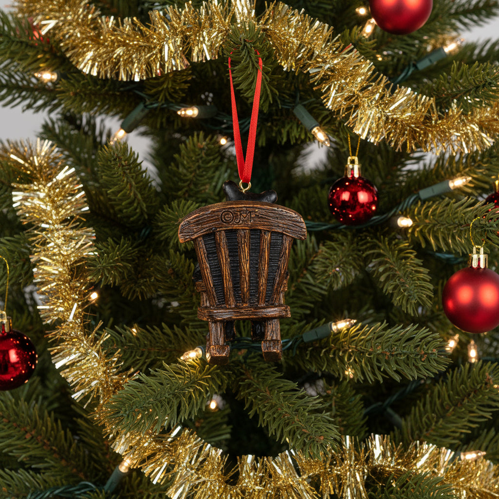 Decorative ornament of a bear and cub on a rocking chair with a red ribbon on a white background