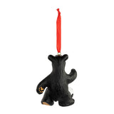 Black bear ornament with red ribbon on a white background