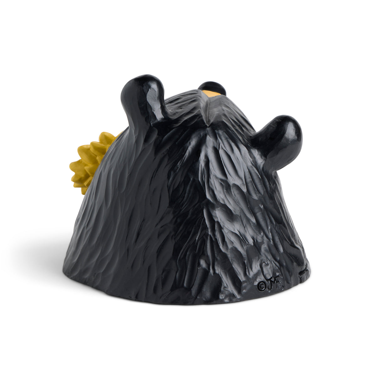 Black bear figurine with a sunflower on a white background