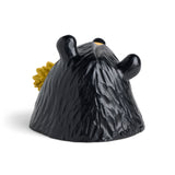 Black bear figurine with a sunflower on a white background