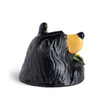 Black bear figurine with a sunflower on a white background