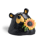 Black bear figurine with a sunflower on a white background