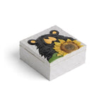 A square white marble keepsake box featuring a sculpted lid design of a black bear face and a yellow sunflower with green leaves, shown on a white background.