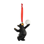 Black bear ornament with a volleyball on a red string against a white background