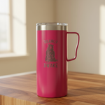 Pink insulated mug with bear design and 'Beary Awake' text on a wooden surface.