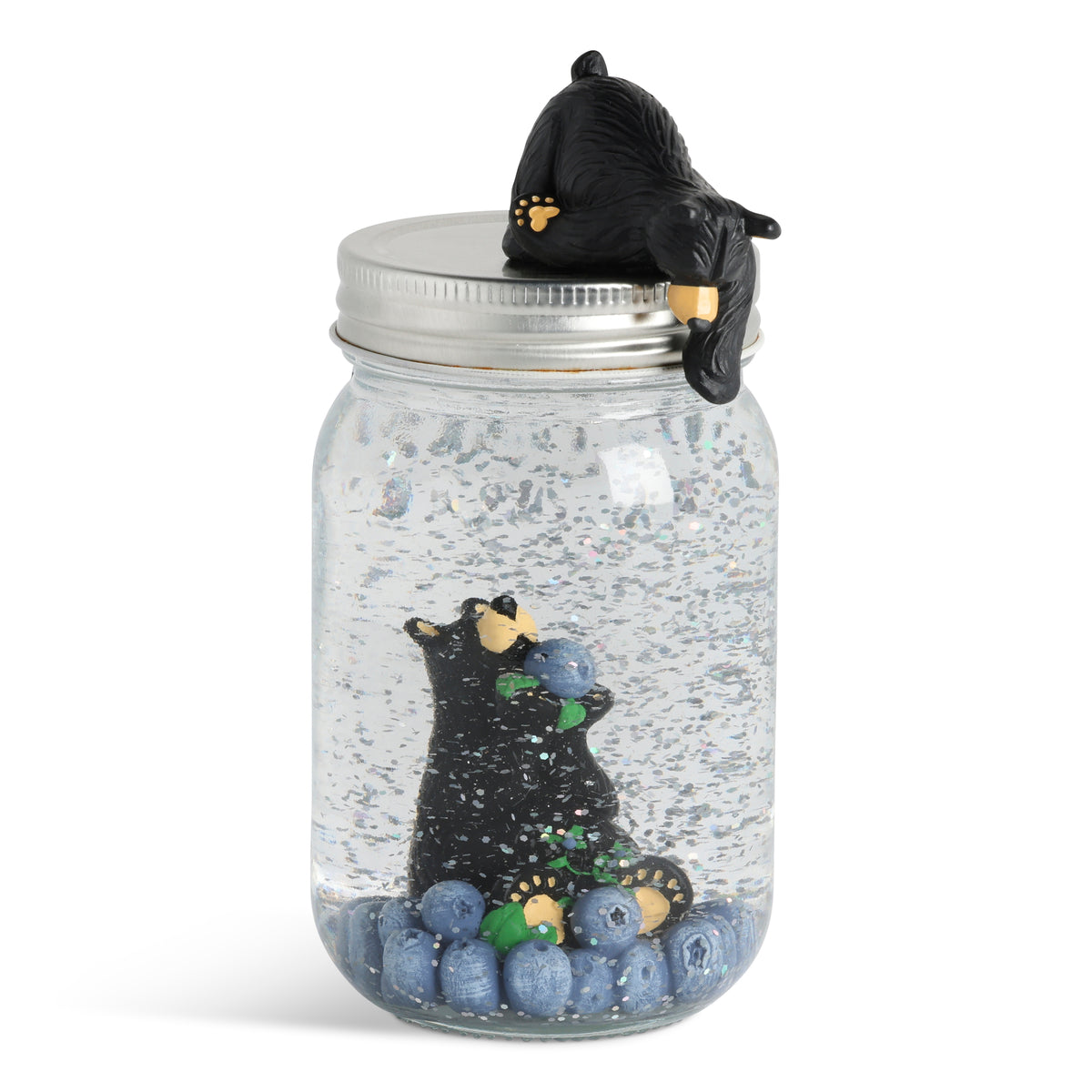Decorative jar with a Bearfoots bear and huckleberries inside, featuring a lid with a Bearfoots bear design.