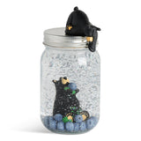 Decorative jar with a Bearfoots bear and huckleberries inside, featuring a lid with a Bearfoots bear design.