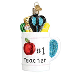 Decorative ornament shaped like a mug with school supplies and 'Number 1 Teacher' text on a white background