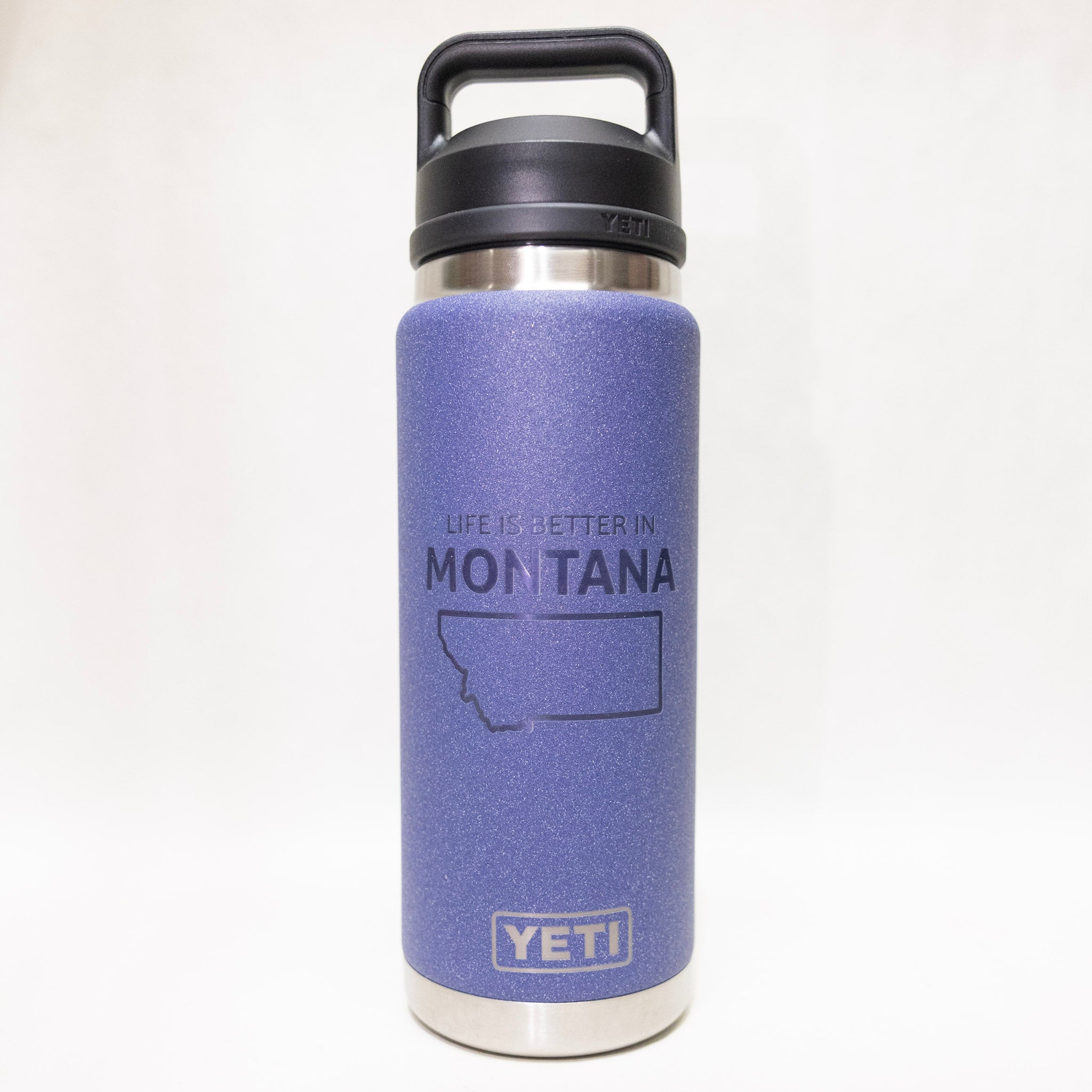 YETI water bottle with purple sleeve and 'Life is Better in Montana' text on a white background