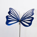 Blue butterfly-shaped decorative object on a white background
