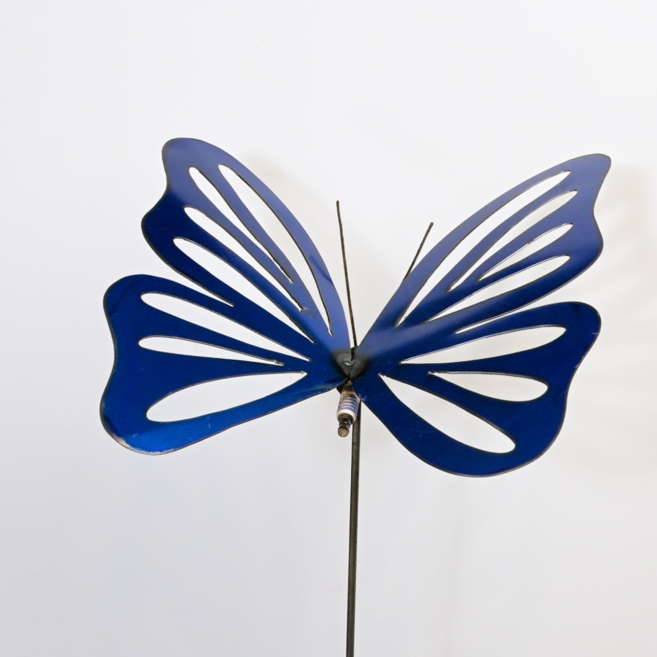 Blue butterfly-shaped decorative object on a white background