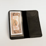 Black leather wallet with a card holder displaying an old one-dollar bill on a light gray background