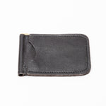 A black textured leather money clip wallet with a gold-tone metal clip, shown on a plain white background.