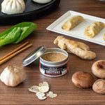 Olive Garden Shiitake seasoning with mushrooms, garlic, and dumplings on a wooden table.